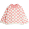 Pull tricoté en coton biologique rose vintage motif damier avec épaules tombantes et finitions côtelées pour enfant