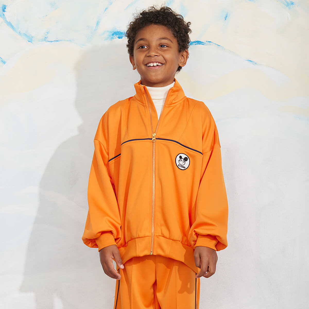 Veste zippée en polyester recyclé à imprimé patchwork orange sportif avec poignets côtelés pour enfant