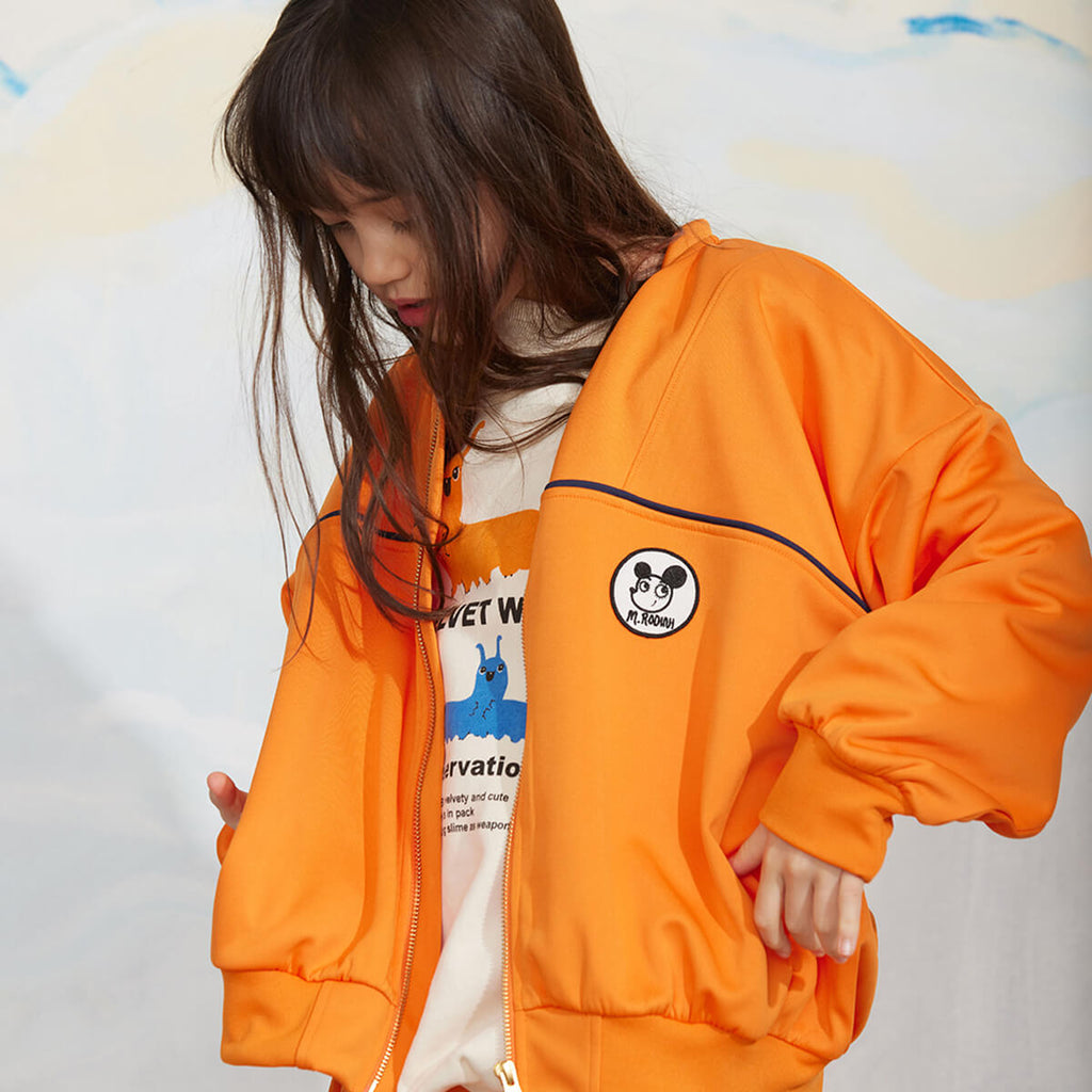 Veste zippée en polyester recyclé à imprimé patchwork orange sportif avec poignets côtelés pour enfant
