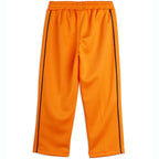Pantalon en polyester recyclé sportif orange à imprimé patchwork, avec taille élastiquée et pli marqué sur le devant pour enfant